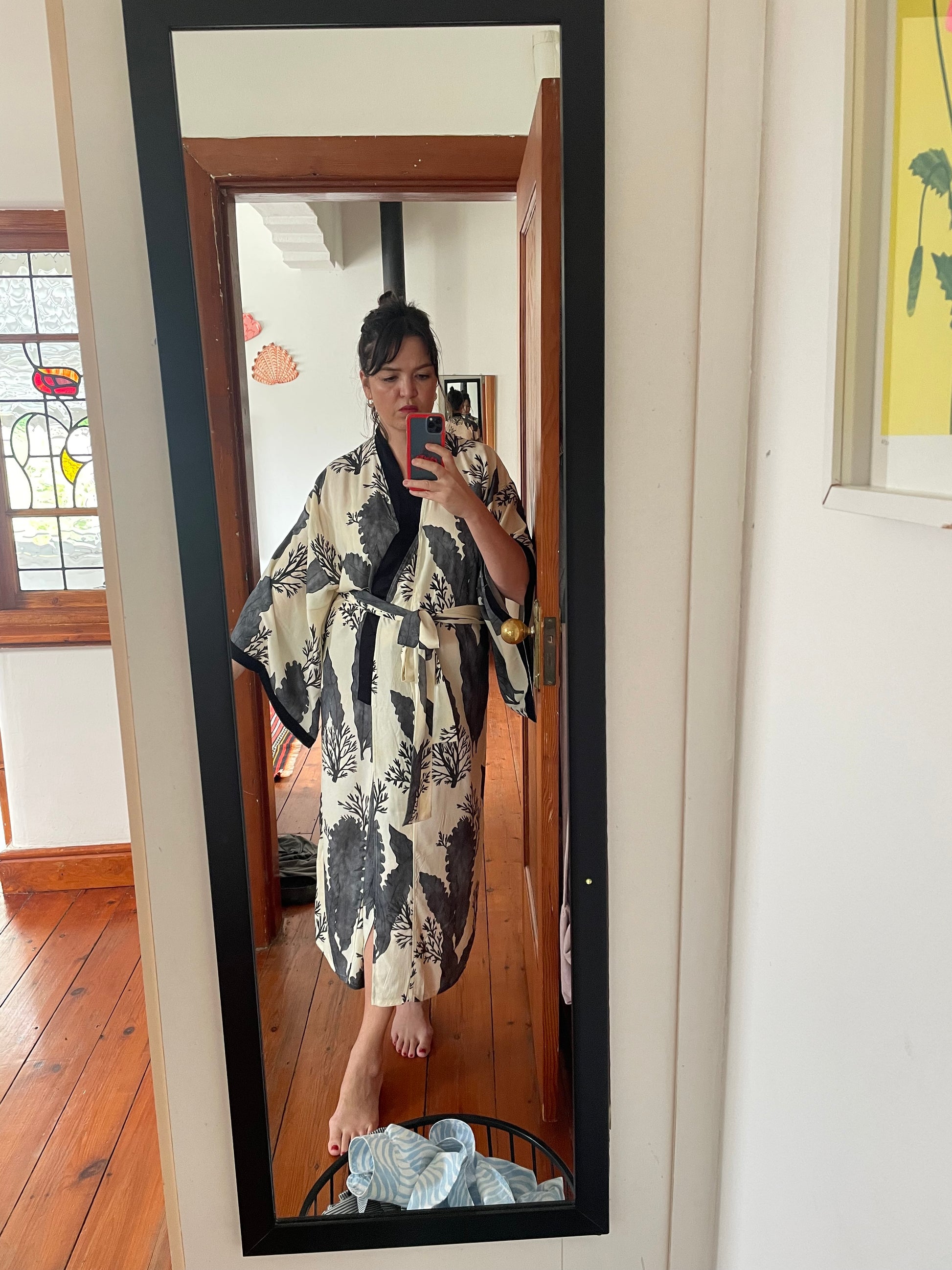 woman wearing printed kimono at home
